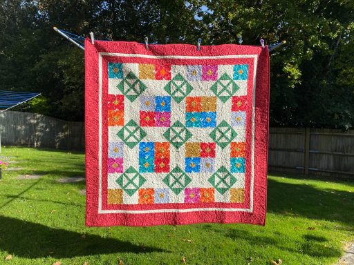 Flower Block Quilt on washing line in the sun